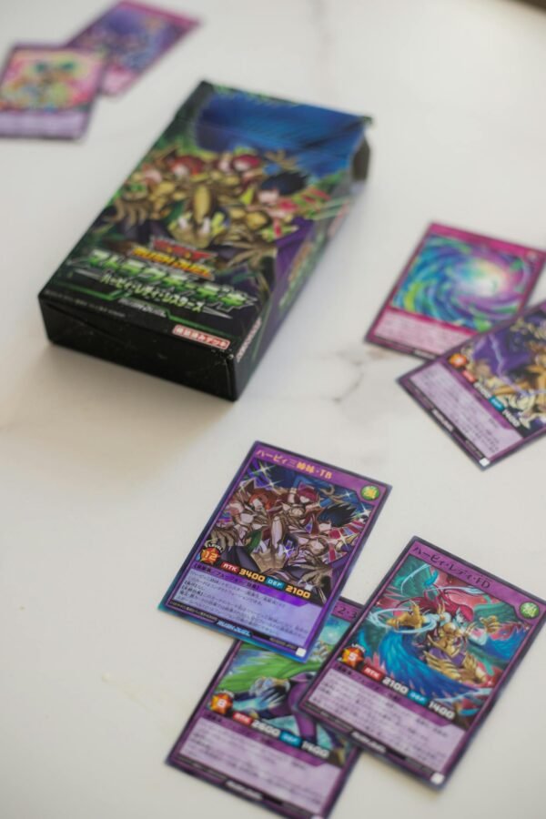 A collection of Yu-Gi-Oh trading cards and a deck box, ideal for card game enthusiasts.