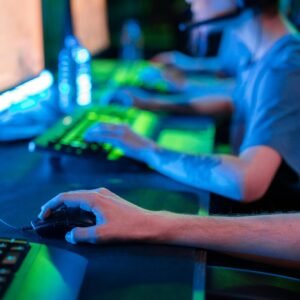 Team of gamers focused on screens during an intense online gaming session.